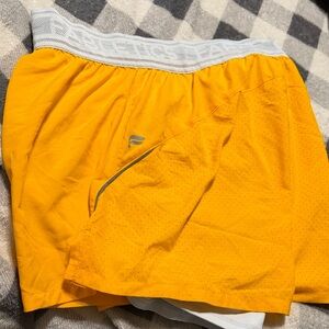 Fabletics women's yellow athletic training shorts with a compression line 5’